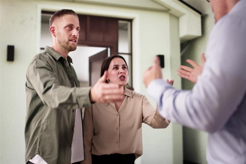 conflict between land lord and tenant , husband and wife arguing with land lord